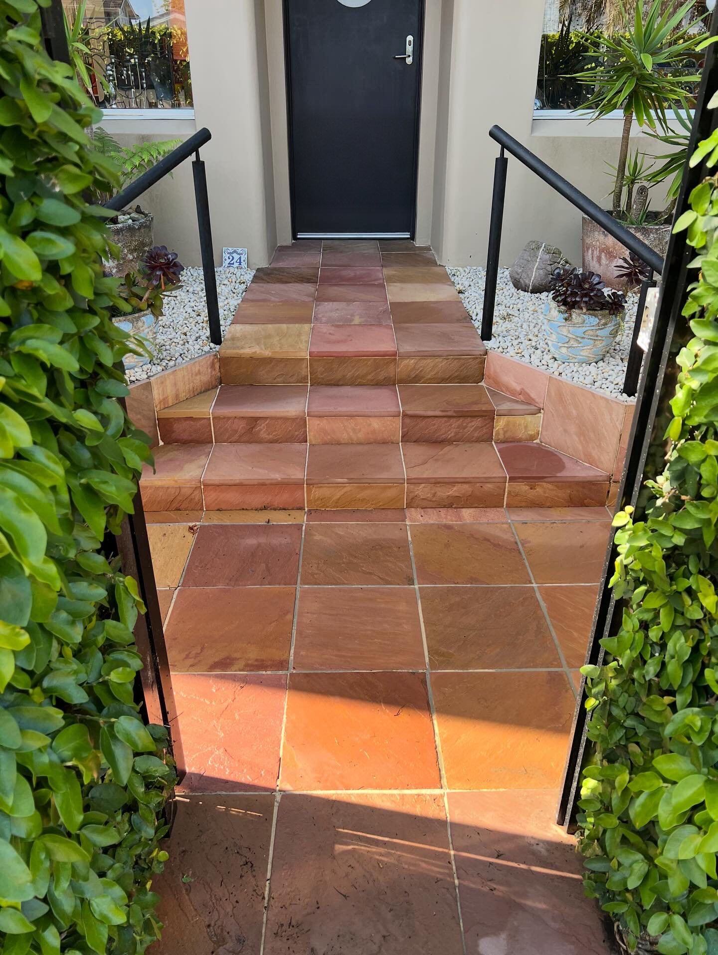 The same sandstone steps and front path after a high pressure clean